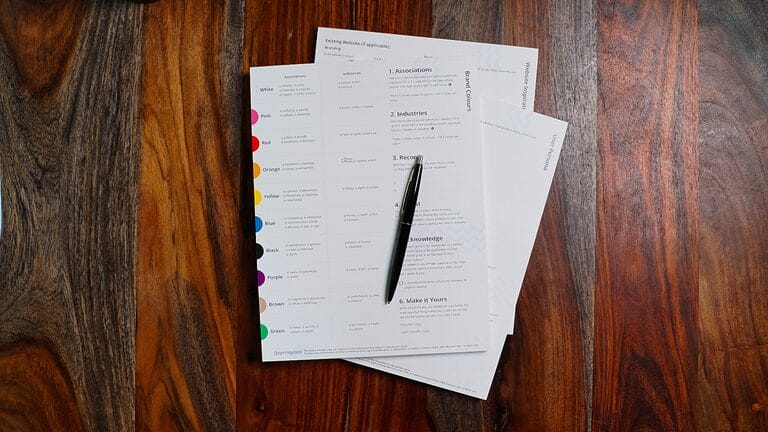 Stack of payroll papers on a desk, representing computing and documenting 13th month pay in the Philippines