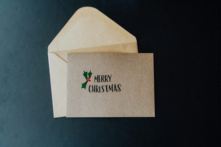 White envelope marked with a Christmas bonus greeting, representing a discretionary year-end cash bonus given to employees in the Philippines