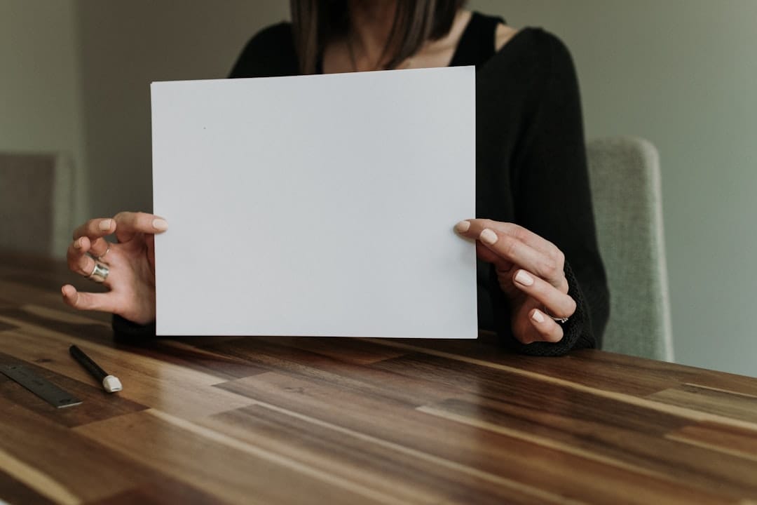 Employee holding a printed employment document, representing a Certificate of Employment request in the Philippines