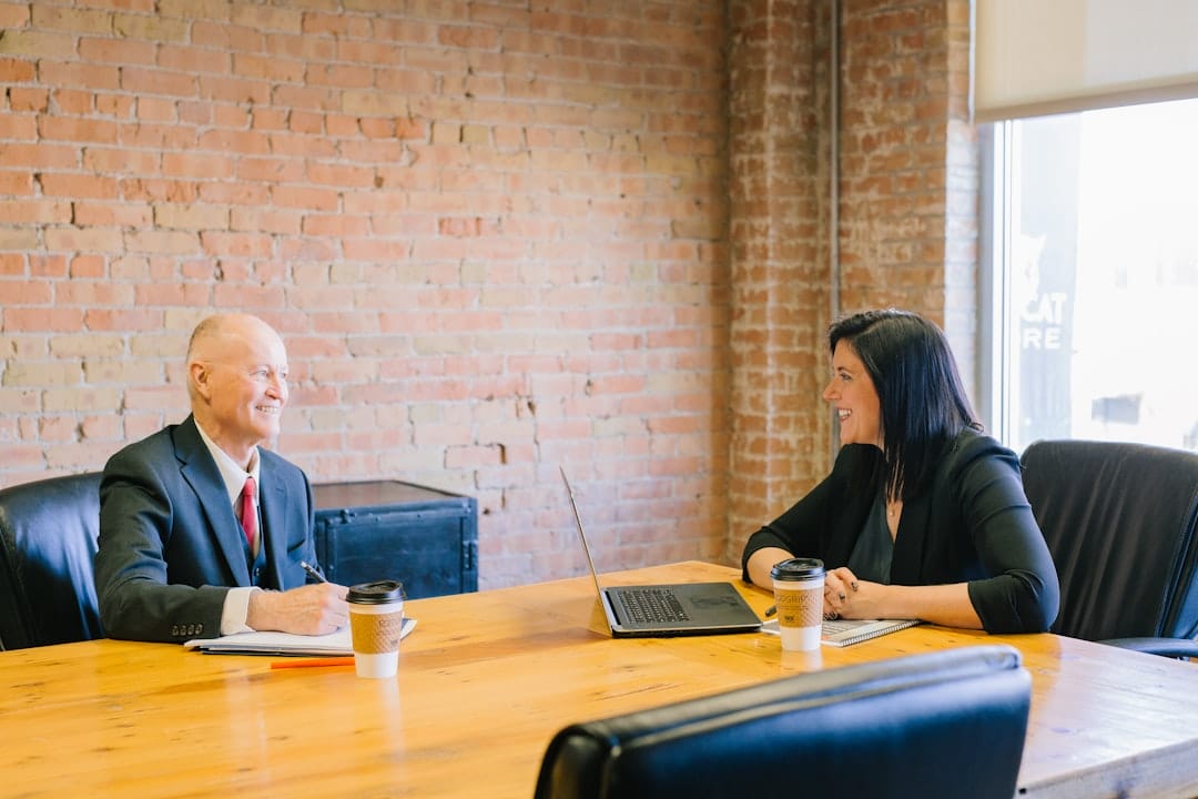 Employee having a serious, confidential conversation with an HR representative to report workplace sexual harassment, reflecting the RA 7877 and Safe Spaces Act complaint process