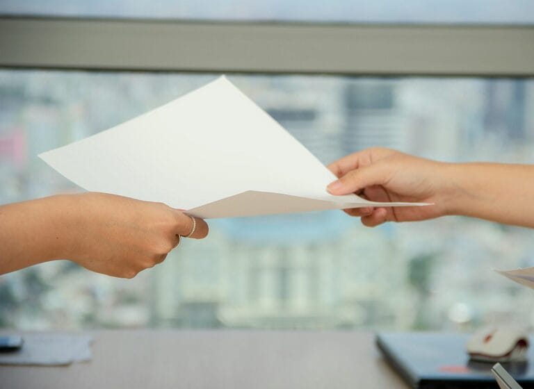 Manager handing an employee a written transfer or reassignment notice in a Philippine workplace