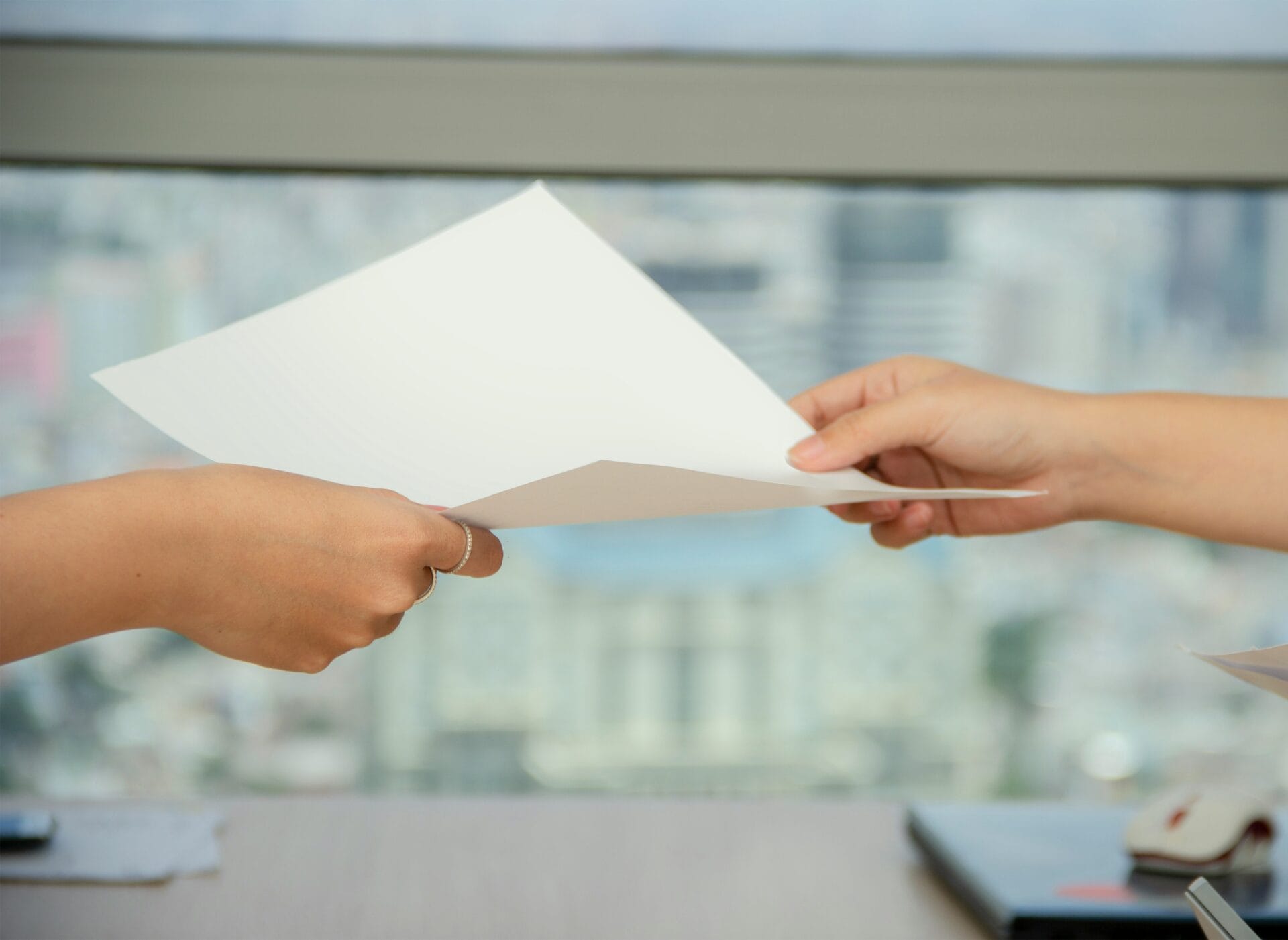 Manager handing an employee a written transfer or reassignment notice in a Philippine workplace