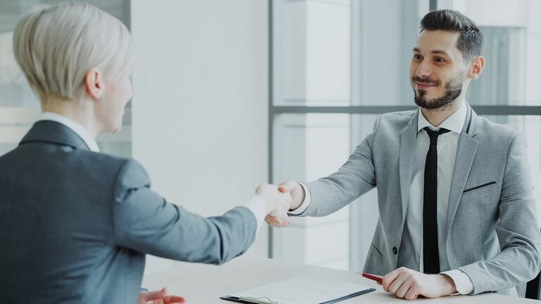 HR manager and job candidate shaking hands after a job offer is accepted, illustrating when an employer can and cannot cancel a signed job offer in the Philippines
