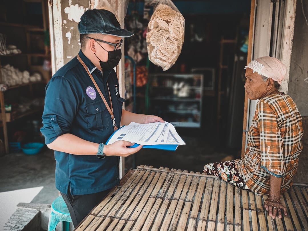 A route worker holding delivery paperwork outdoors, illustrating field personnel under Article 82 of the Philippine Labor Code who work away from the employer's office