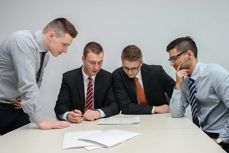 Colleagues reviewing a document seriously at a table, representing a workplace investigation into serious misconduct in the Philippines