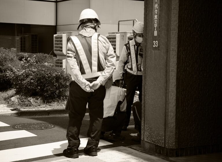 Two workers in hard hats and reflective vests at a Philippine jobsite, one directing the other — illustrating the control an employer exercises over the means and methods of work under the Labor Code four-fold test