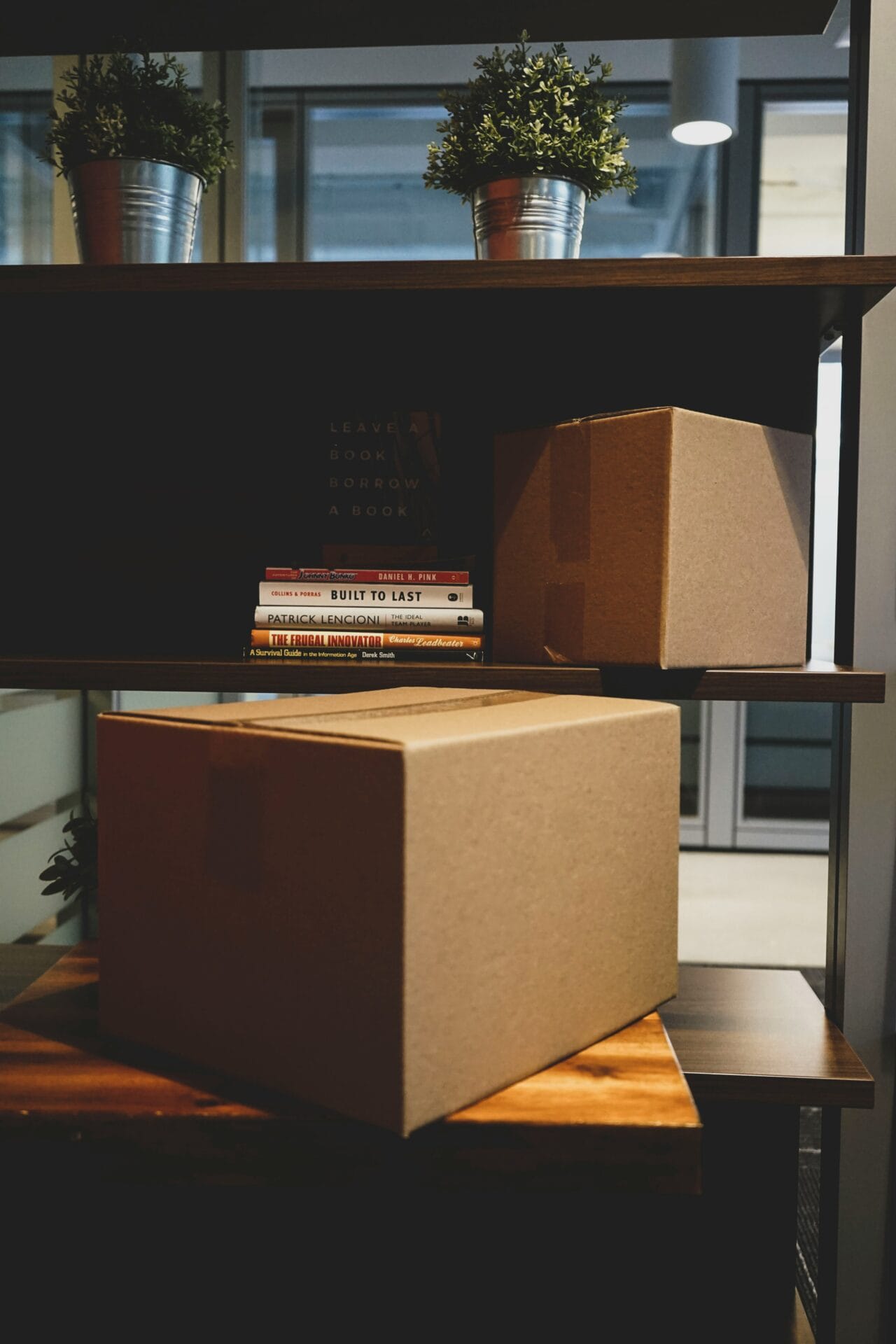 Employee's cardboard box of personal belongings packed on an office desk during company clearance before final pay release in the Philippines