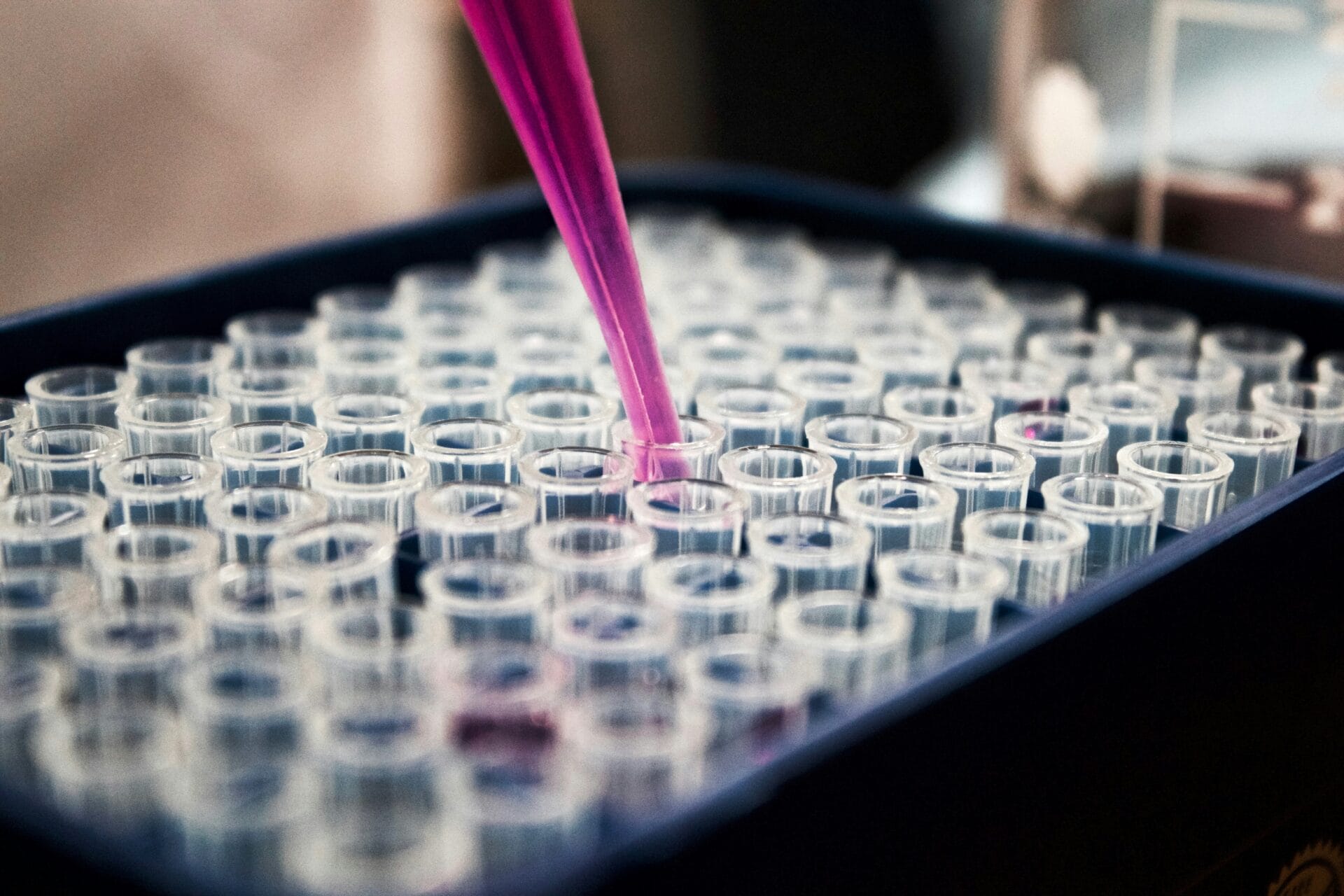 Laboratory technician using a pipette to process a sample tube during confirmatory drug testing analysis at a DOH-accredited laboratory